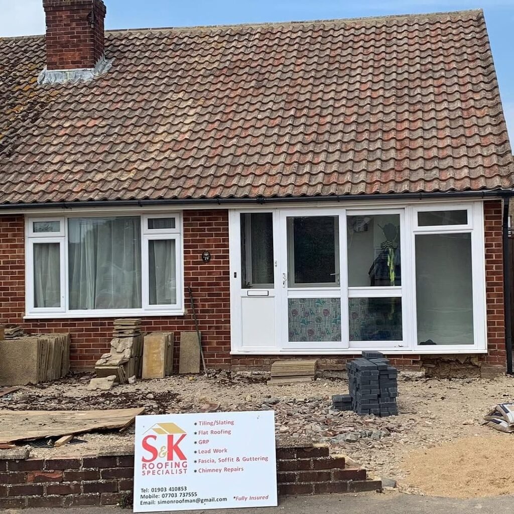 Bungalow re-roof in Lancing with S&K Roofing Specialist site board