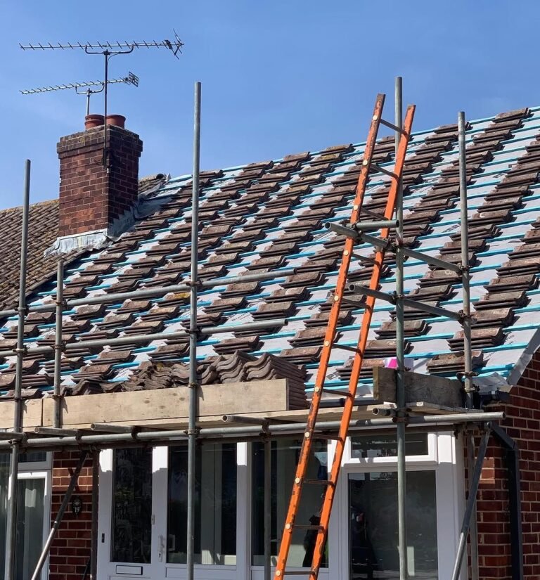 Old tiles stripped from a roof before a full re-roof in Worthing
