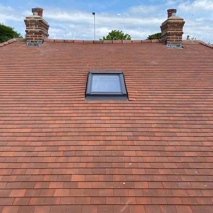 Plain tile roof with chimneys and a Velux window in Shoreham-by-Sea