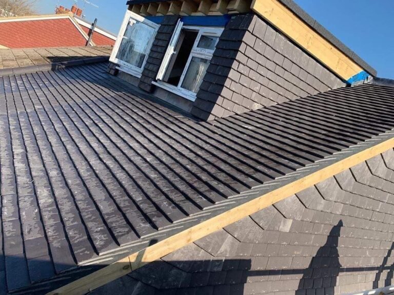Roof window fitted into a slate roof on a dormer in Worthing