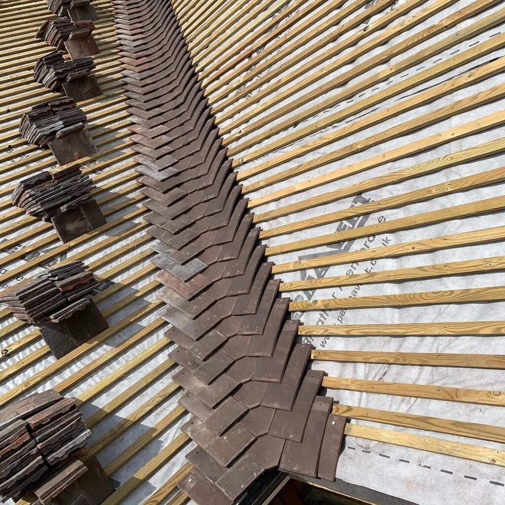 Roofing battens and clay tiles being laid on a re-roof in Worthing