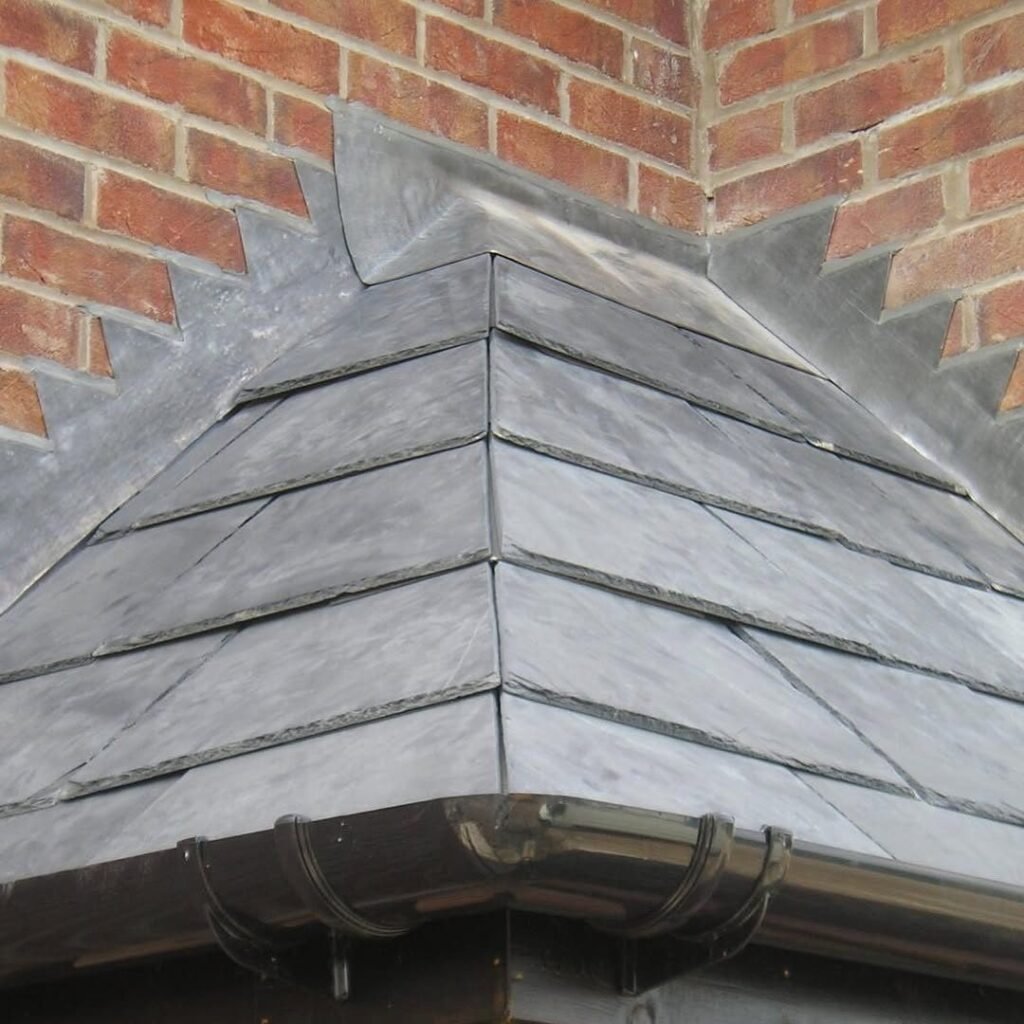 Slate hip with lead soakers and new guttering on a house in Worthing