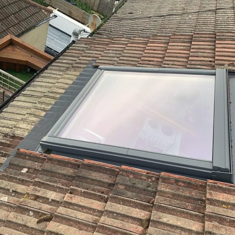 Velux window flashing fitted into an old tiled roof in Worthing